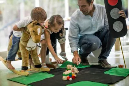 Teacher teaching road safety rules to children