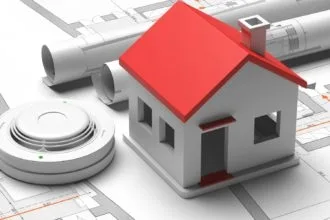 Smoke detector and small house on blueprint drawing background. Fire safety system. 3d illustration